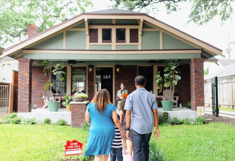A family walking into their new home in Buda, Texas